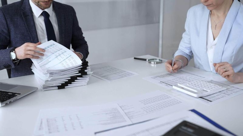 Man and woman reviewing documents for a law