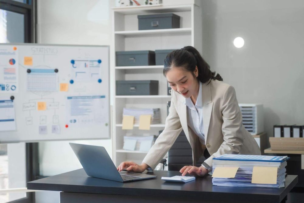 Woman using a laptop to manage a law firm chart