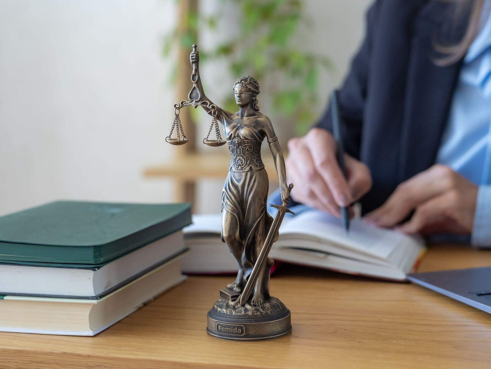 Lady lawyer at a desk with a book and Lady
